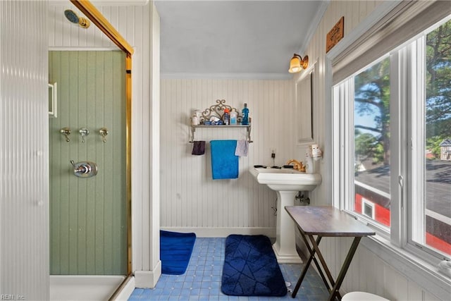 bathroom featuring a stall shower and ornamental molding