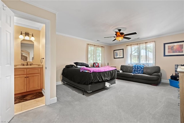 bedroom with a sink, baseboards, carpet floors, and ornamental molding