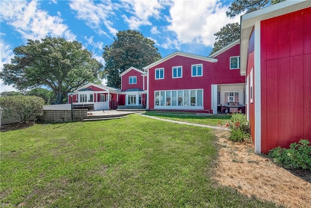 rear view of property with a patio area and a yard