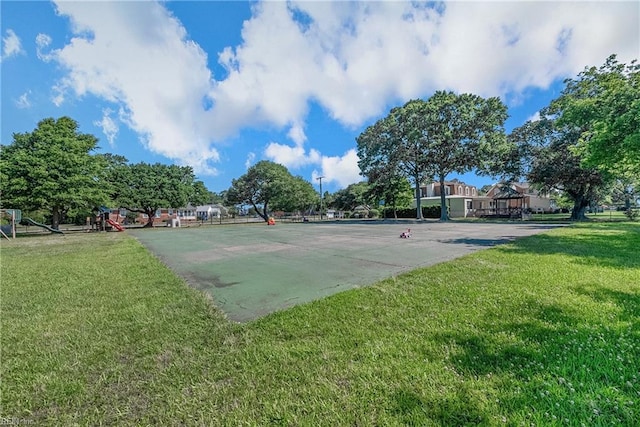 view of home's community featuring a lawn and community basketball court