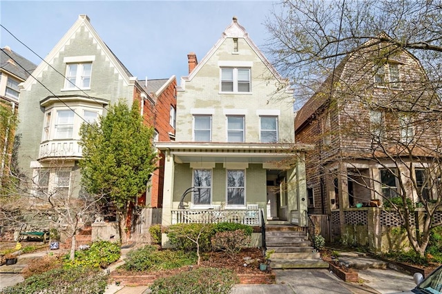 view of front of property with a porch and brick siding