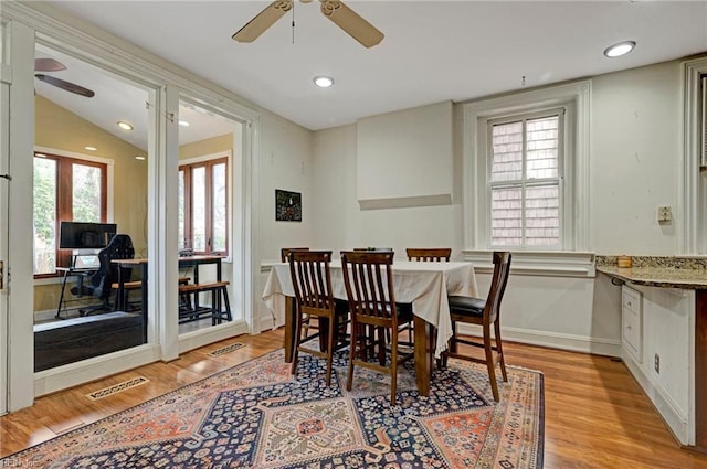 dining area with light wood finished floors, baseboards, visible vents, and recessed lighting