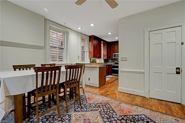 dining space with light wood-type flooring, ceiling fan, and recessed lighting