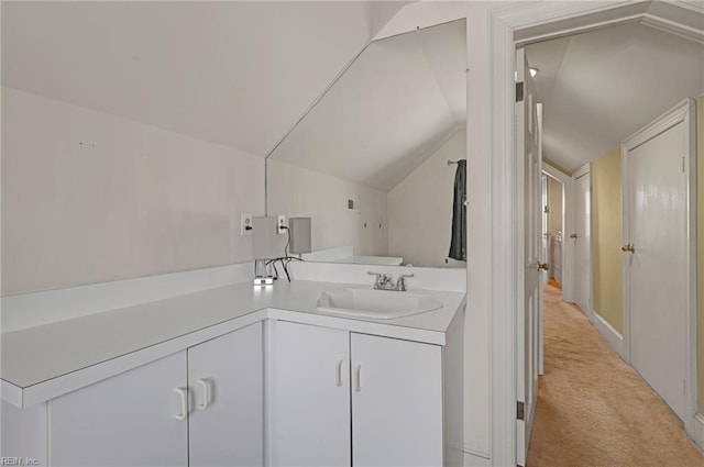 clothes washing area with light colored carpet and a sink