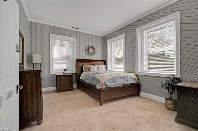 bedroom with light colored carpet, crown molding, visible vents, and baseboards