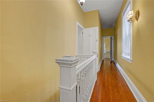 hall with wood finished floors and baseboards