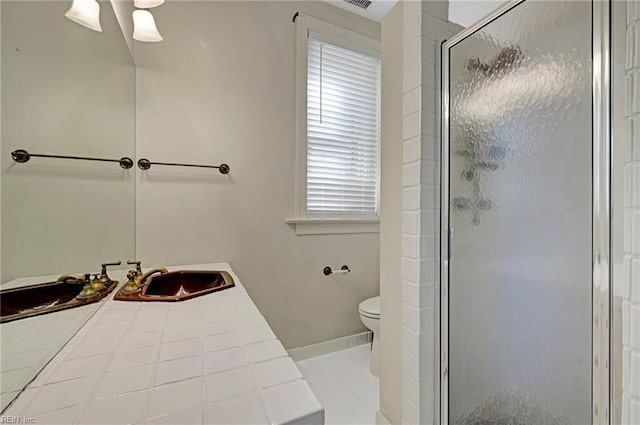 full bath featuring baseboards, toilet, tile patterned floors, a shower stall, and a sink