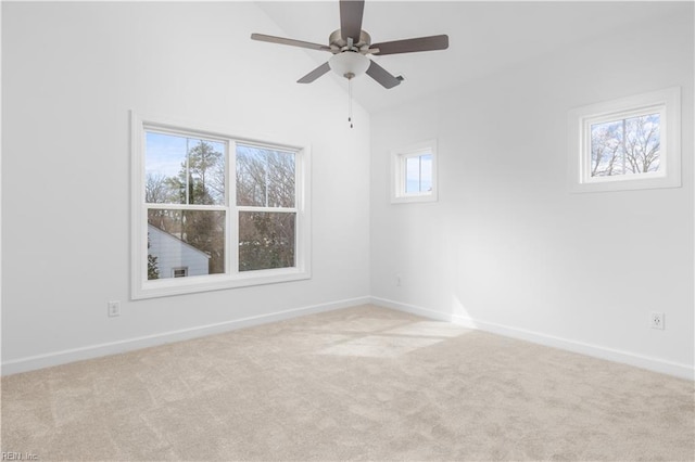 empty room featuring baseboards, a ceiling fan, carpet, and vaulted ceiling