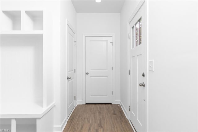 hallway with baseboards and wood finished floors