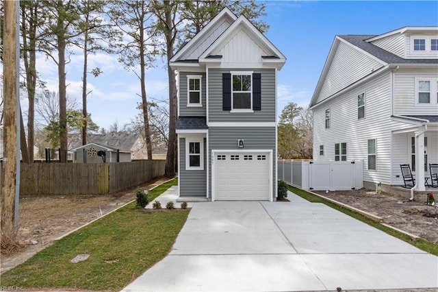 traditional-style house with a garage, board and batten siding, driveway, and fence