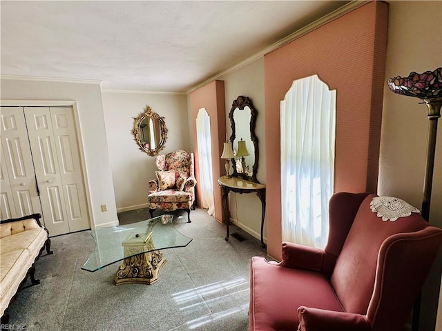 sitting room with carpet flooring, baseboards, and crown molding