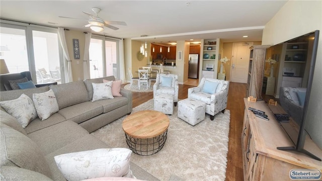 living area featuring wood finished floors and a ceiling fan