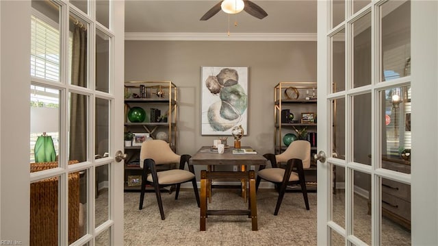 sitting room with ceiling fan, french doors, light carpet, and crown molding