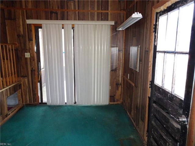 miscellaneous room with wood walls