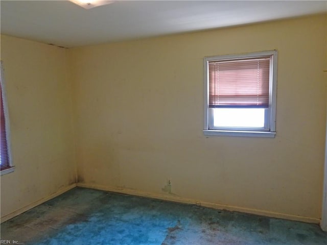 carpeted spare room with baseboards