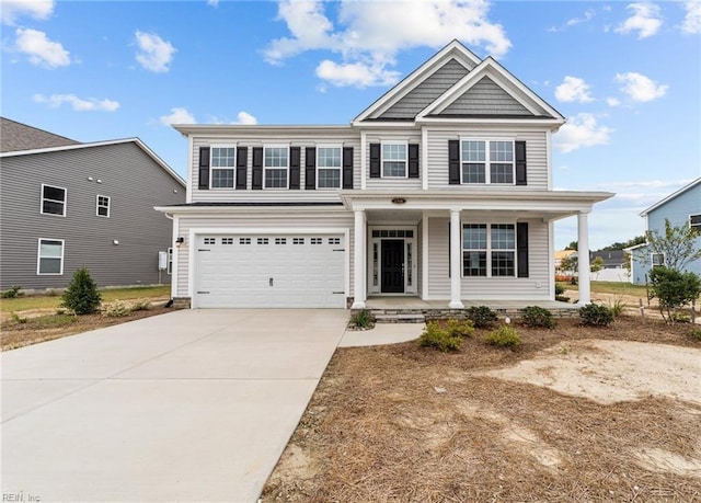 view of front of house featuring covered porch, driveway, and a garage