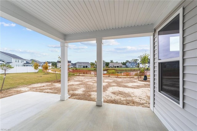 view of patio featuring a residential view and fence