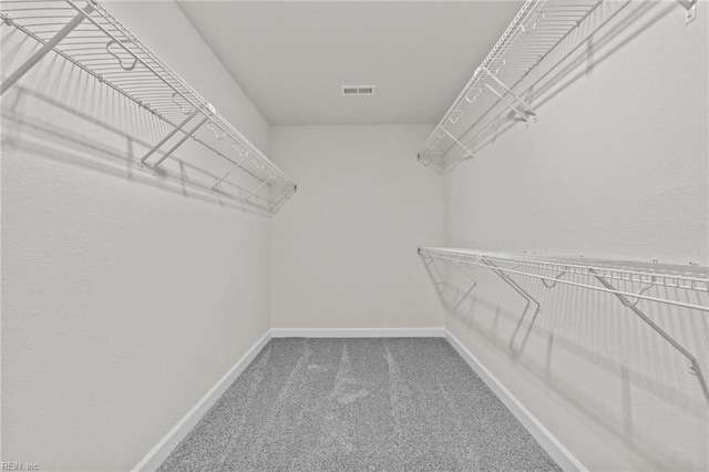 spacious closet with carpet floors and visible vents