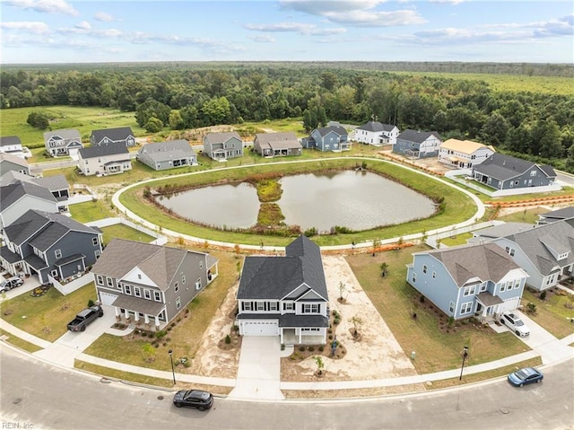 aerial view with a water view, a wooded view, and a residential view