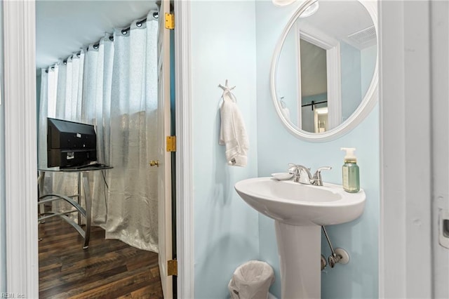 bathroom with a sink, visible vents, and wood finished floors