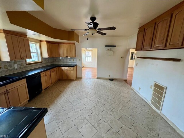 kitchen with tasteful backsplash, baseboards, visible vents, dishwasher, and dark countertops