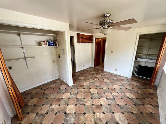 interior space with ceiling fan, baseboards, and tile patterned floors