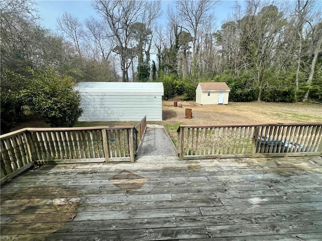 wooden terrace with a shed, a lawn, and an outdoor structure