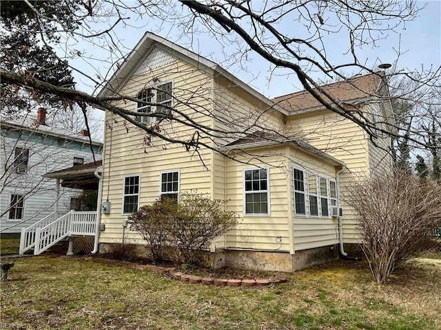 view of side of property with a lawn