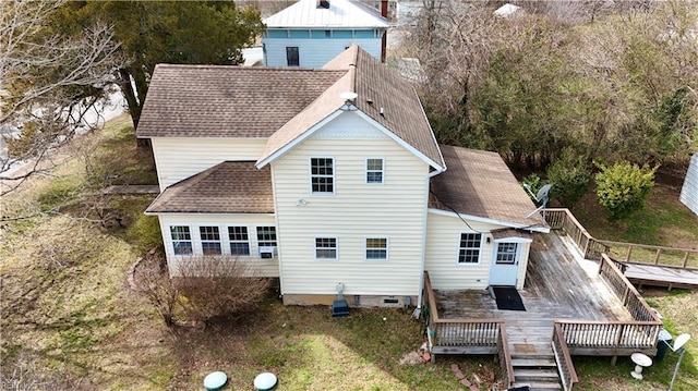 rear view of property featuring a deck, cooling unit, and roof with shingles