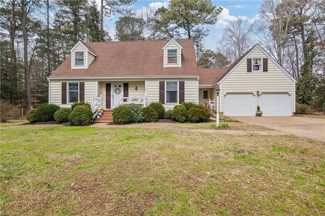 new england style home with a porch, a front lawn, driveway, and a shingled roof