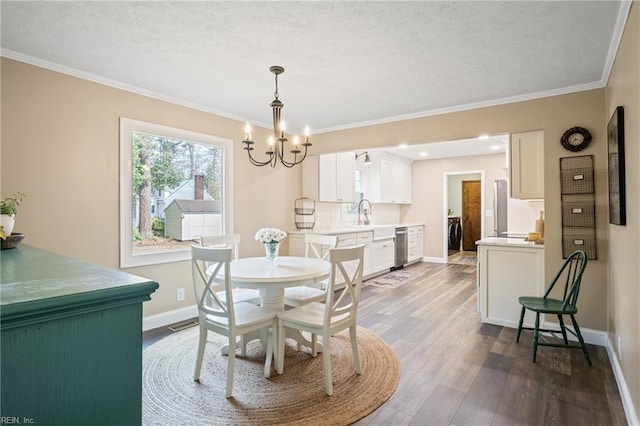 dining area with baseboards, dark wood finished floors, ornamental molding, an inviting chandelier, and a textured ceiling