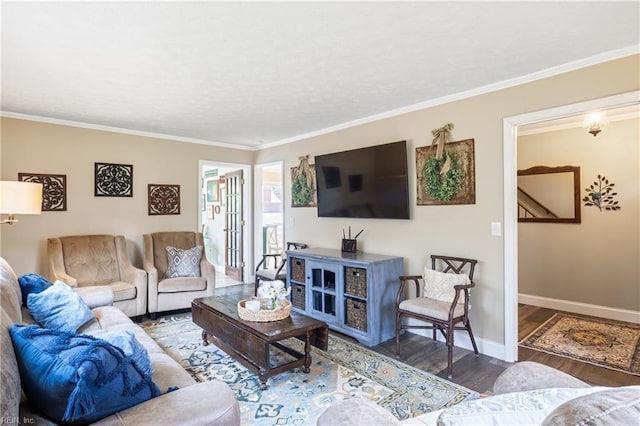 living room with crown molding, wood finished floors, baseboards, and a textured ceiling