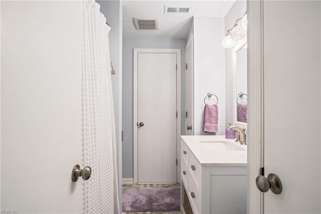 bathroom featuring vanity, a shower with shower curtain, and visible vents