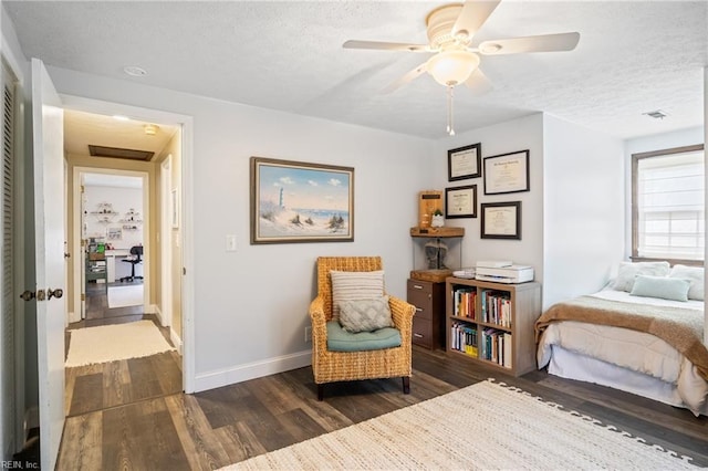 bedroom with dark wood-style floors, visible vents, and a textured ceiling