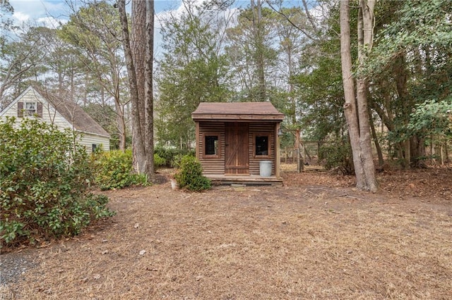 view of front facade with an outbuilding and faux log siding