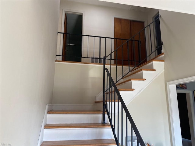 stairs featuring a towering ceiling