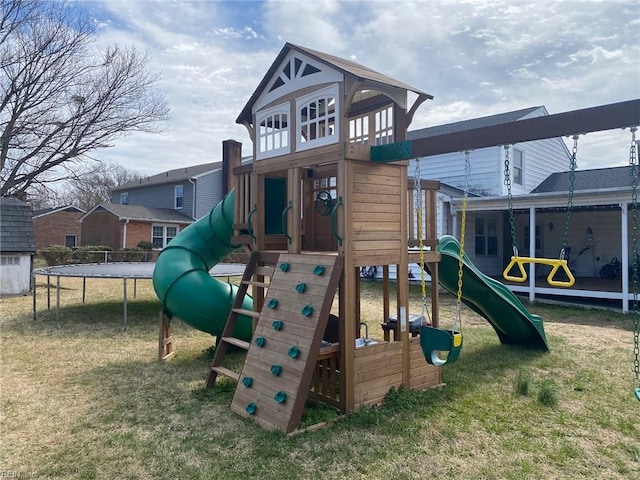 view of play area featuring a trampoline and a lawn