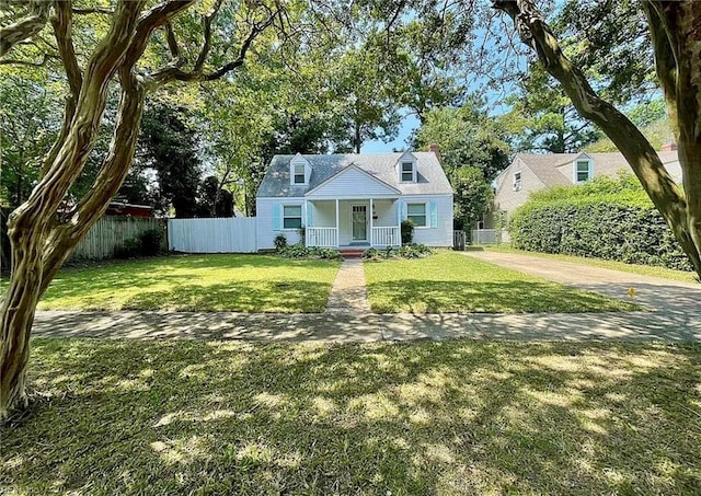 cape cod home featuring a porch, fence, and a front lawn