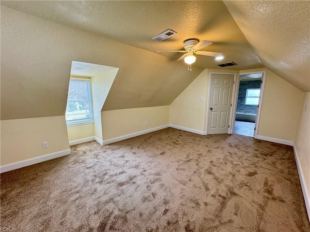 bonus room featuring baseboards, visible vents, and carpet flooring