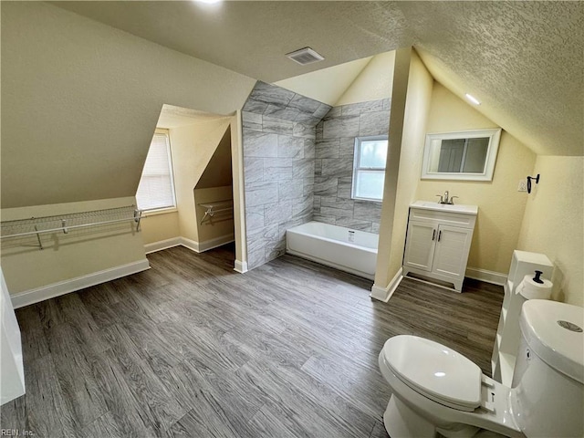 full bathroom with baseboards, a textured ceiling, toilet, and wood finished floors