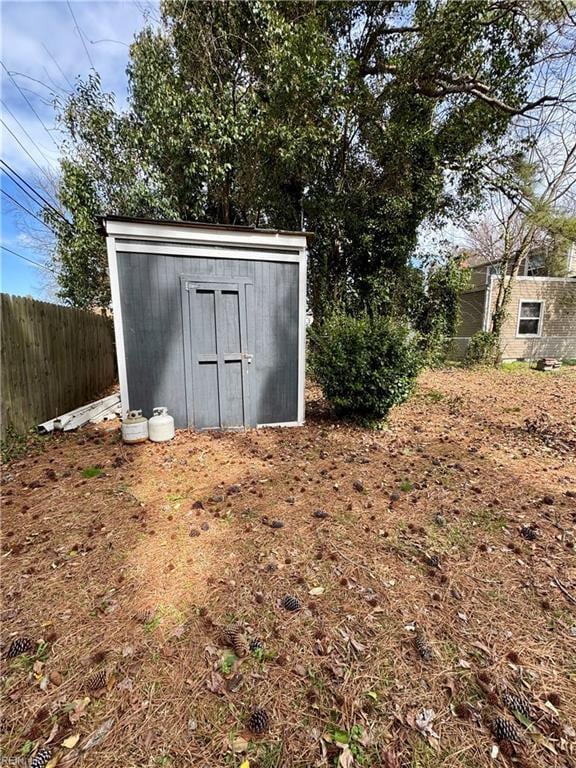 view of shed with fence