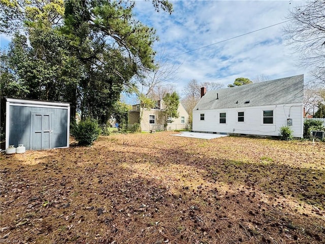 view of yard featuring a patio area, a storage shed, fence, and an outdoor structure