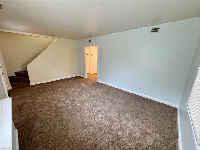 interior space with baseboards, visible vents, and carpet flooring