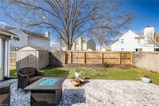 view of yard with an outdoor structure, an outdoor fire pit, a patio, and a storage shed