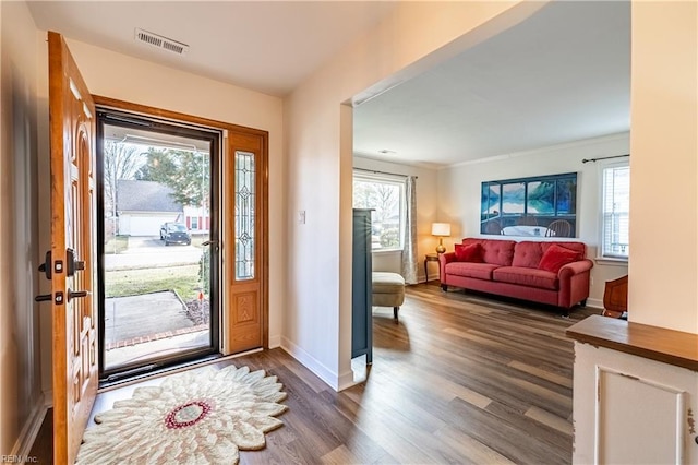 entrance foyer featuring baseboards, visible vents, and dark wood-type flooring