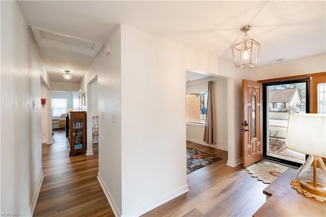 entryway featuring wood finished floors, visible vents, and baseboards