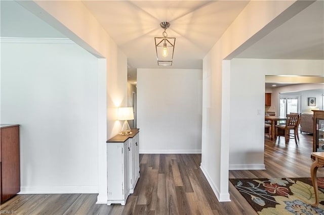 foyer featuring dark wood-style floors and baseboards