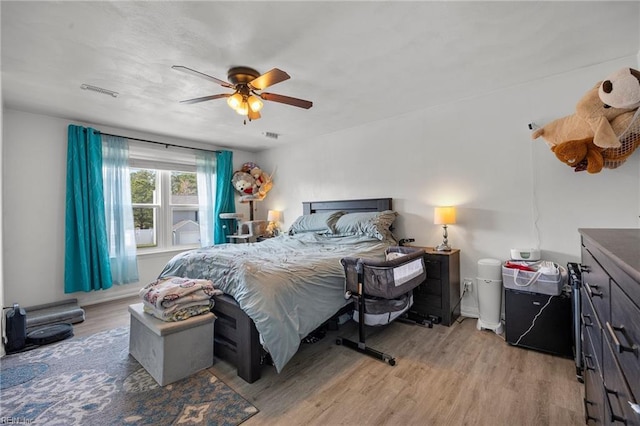 bedroom with a ceiling fan and light wood-style flooring