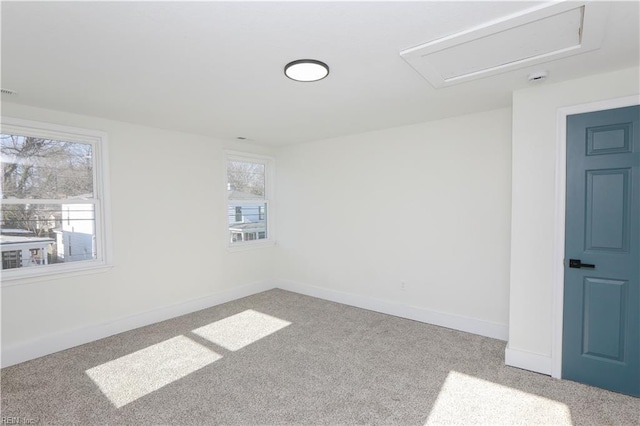 unfurnished room featuring baseboards and light colored carpet