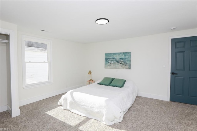 carpeted bedroom featuring baseboards